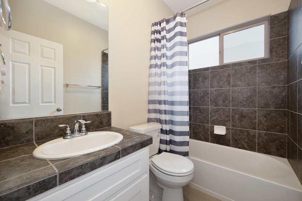 1916 Hartsfield Way Lincoln, CA 95648 - Photo 23 of 35 a bathroom with a granite countertop sink and a mirror