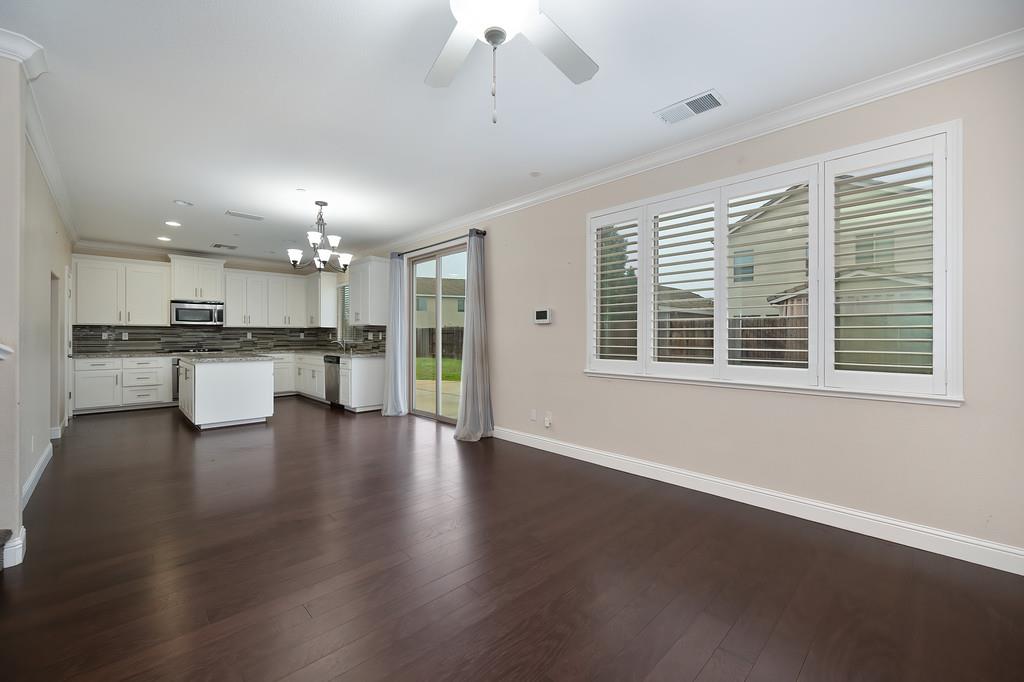 1916 Hartsfield Way Lincoln, CA 95648 - Photo 4 of 35 a large open kitchen with a refrigerator a stove a sink dishwasher with a dining table and chairs