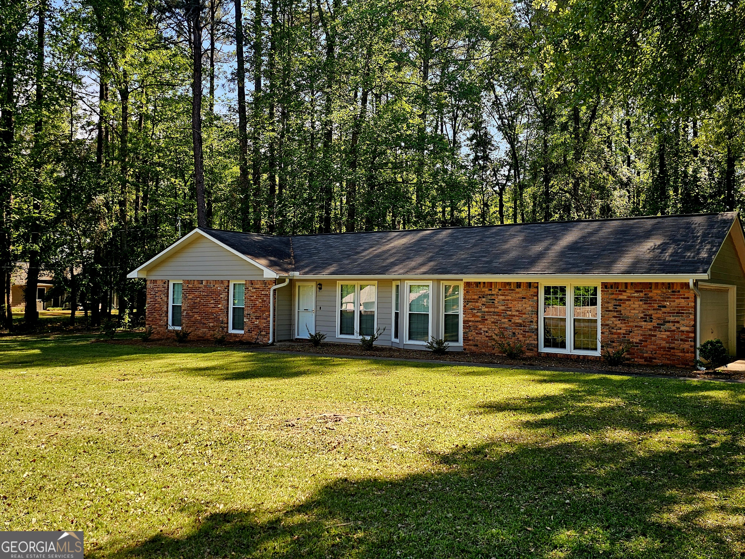 a view of a house with swimming pool and a yard