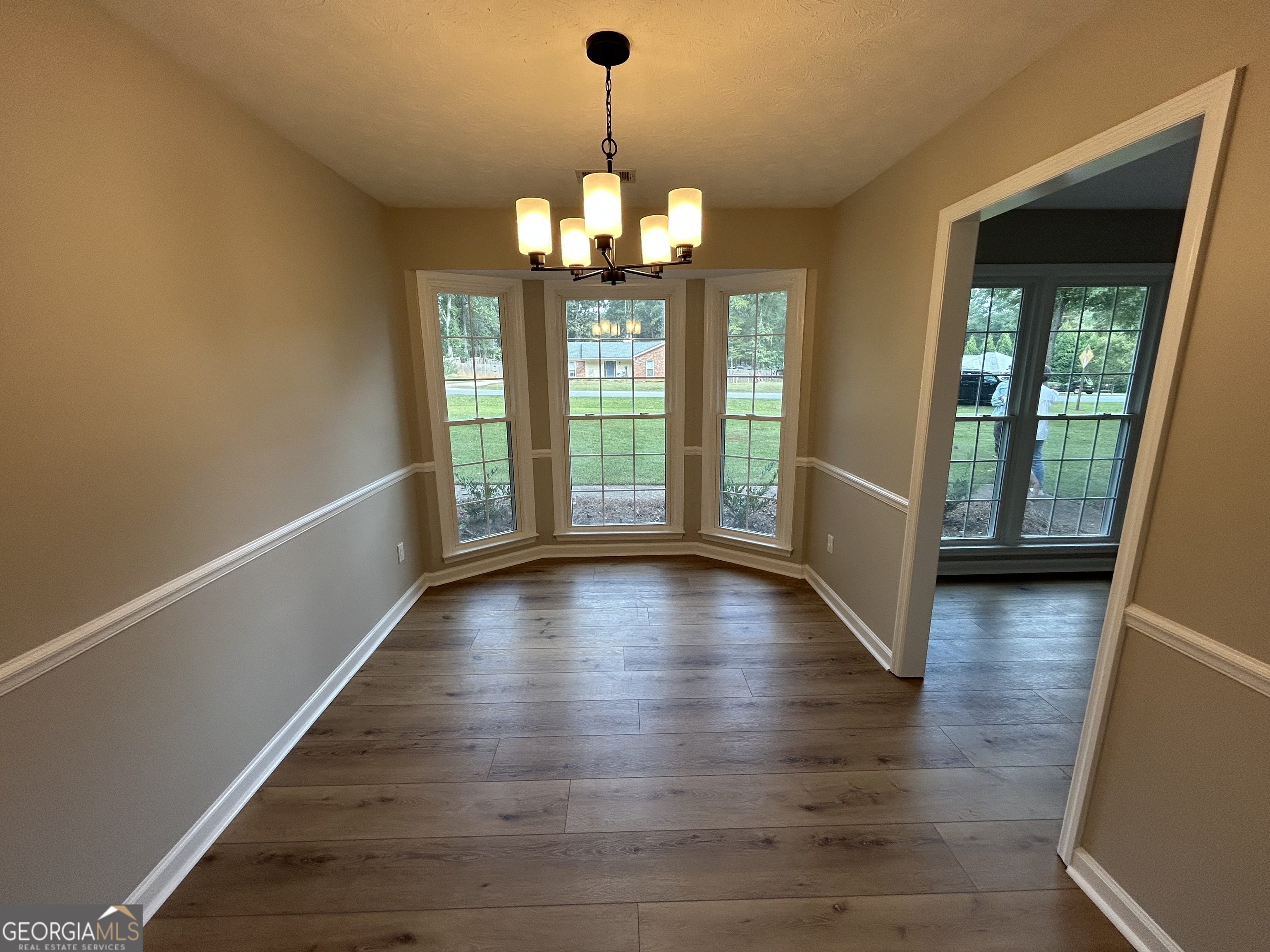 191 Moccasin Trail LaGrange, GA 30241 - Photo 13 of 32 a view of an empty room with wooden floor and a window