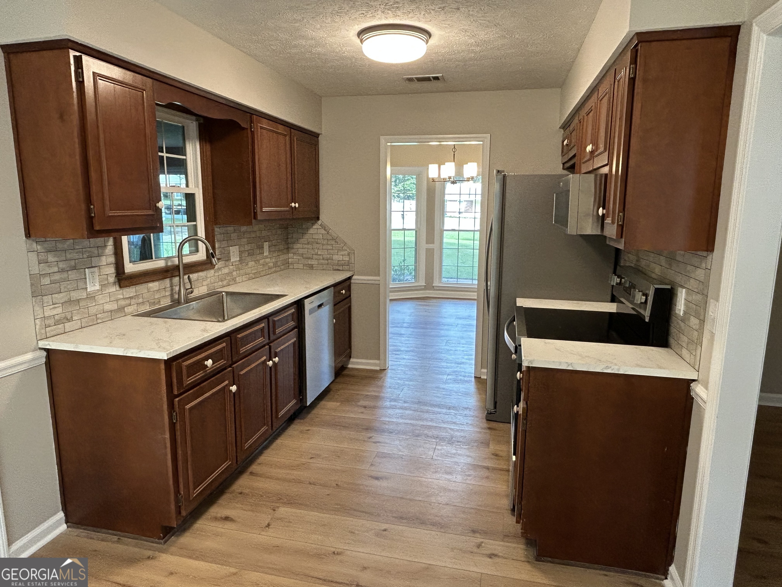 191 Moccasin Trail LaGrange, GA 30241 - Photo 15 of 32 a kitchen with wooden cabinets and a sink