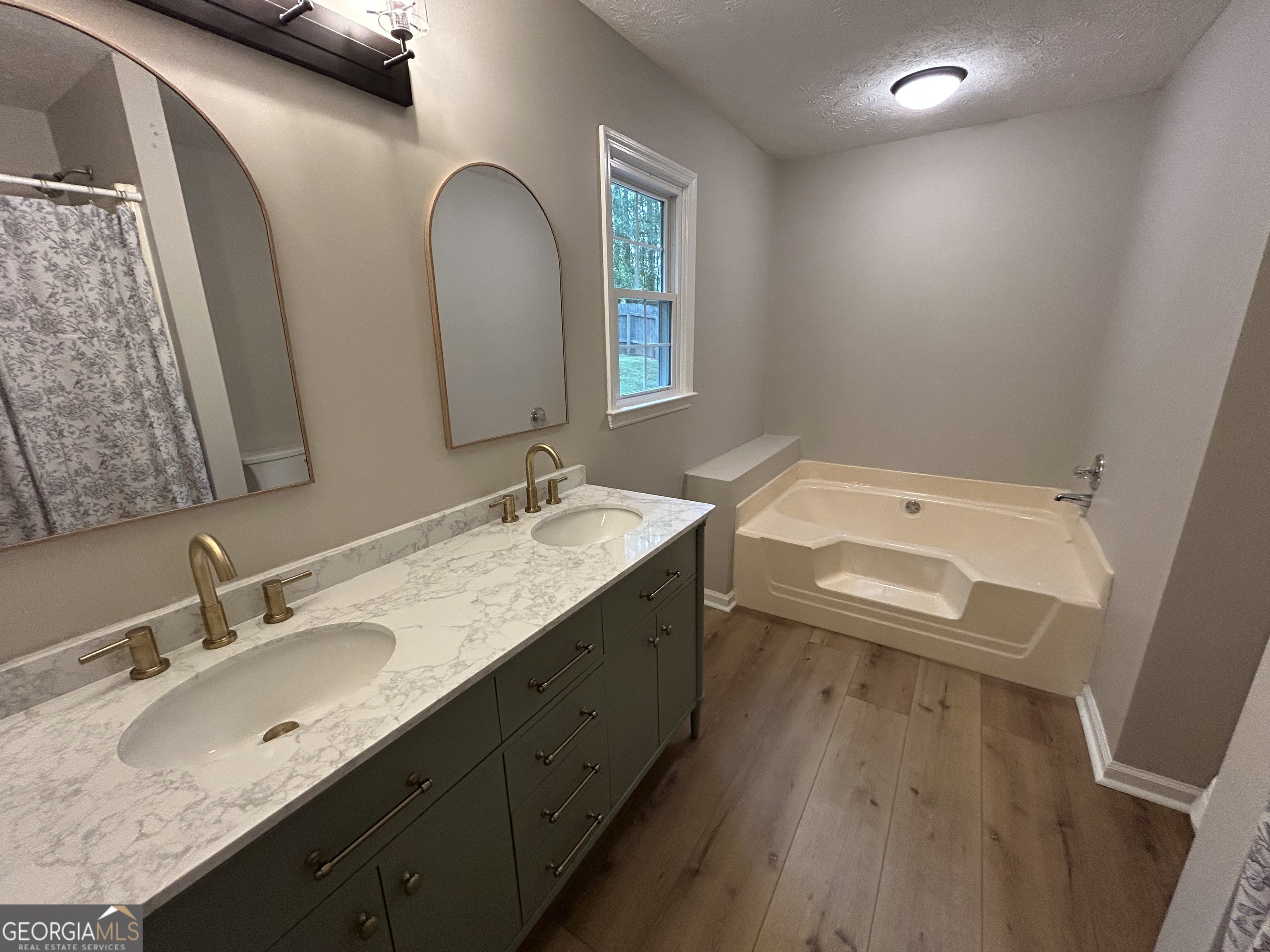 191 Moccasin Trail LaGrange, GA 30241 - Photo 20 of 32 a bathroom with a granite countertop sink a toilet and a mirror