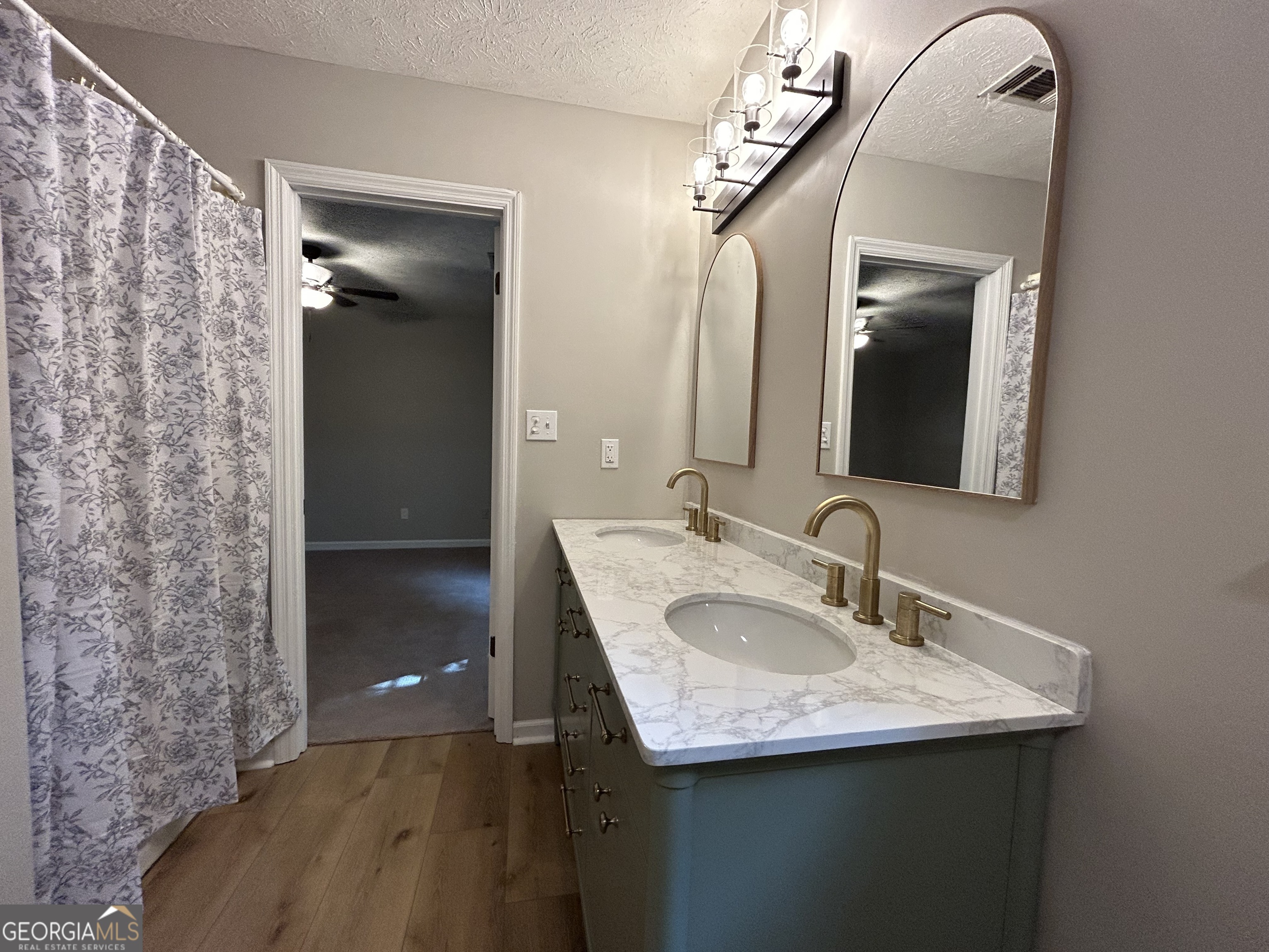 191 Moccasin Trail LaGrange, GA 30241 - Photo 21 of 32 a bathroom with a sink and a mirror