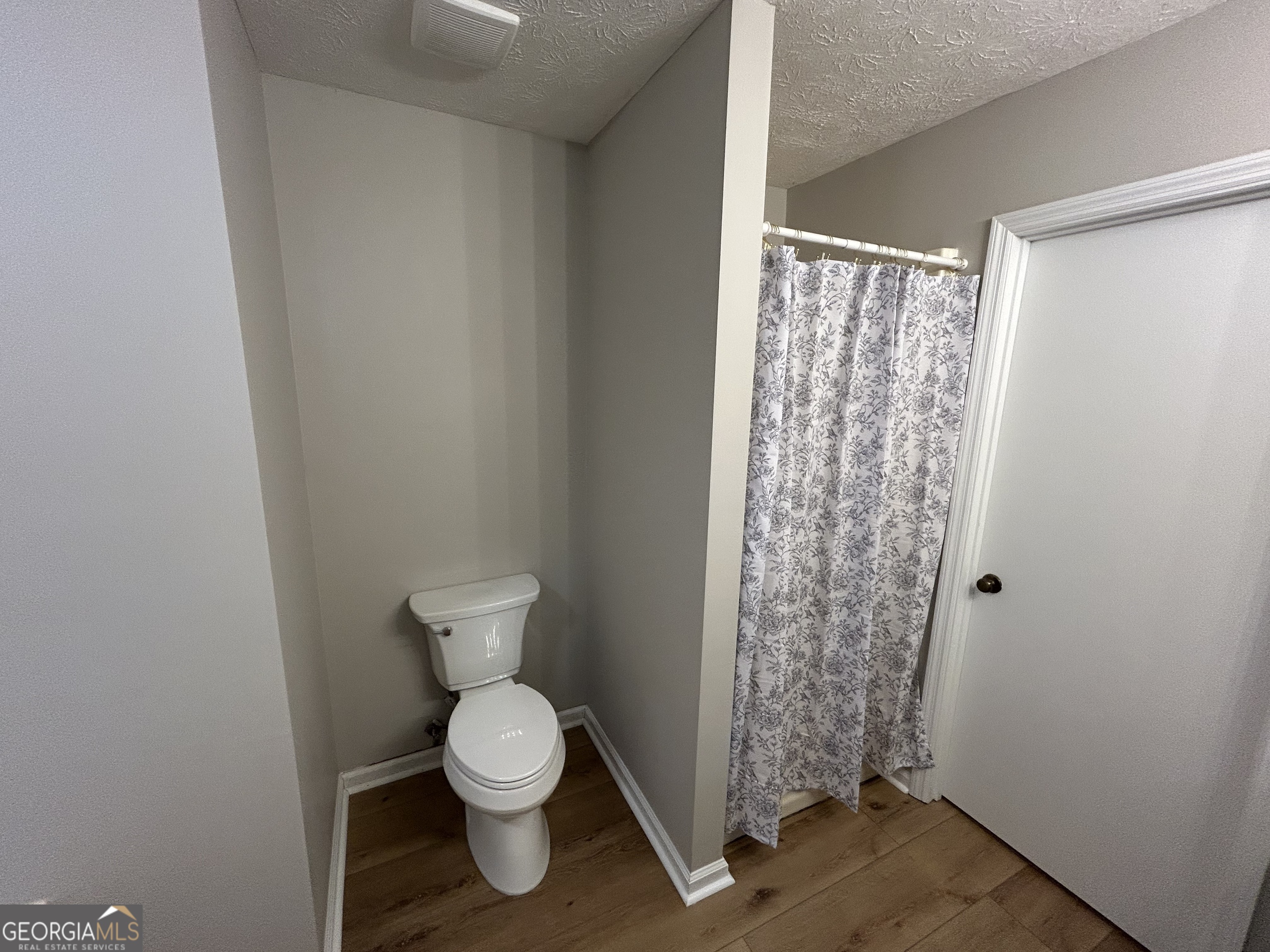 191 Moccasin Trail LaGrange, GA 30241 - Photo 22 of 32 a bathroom with a toilet and a shower curtain