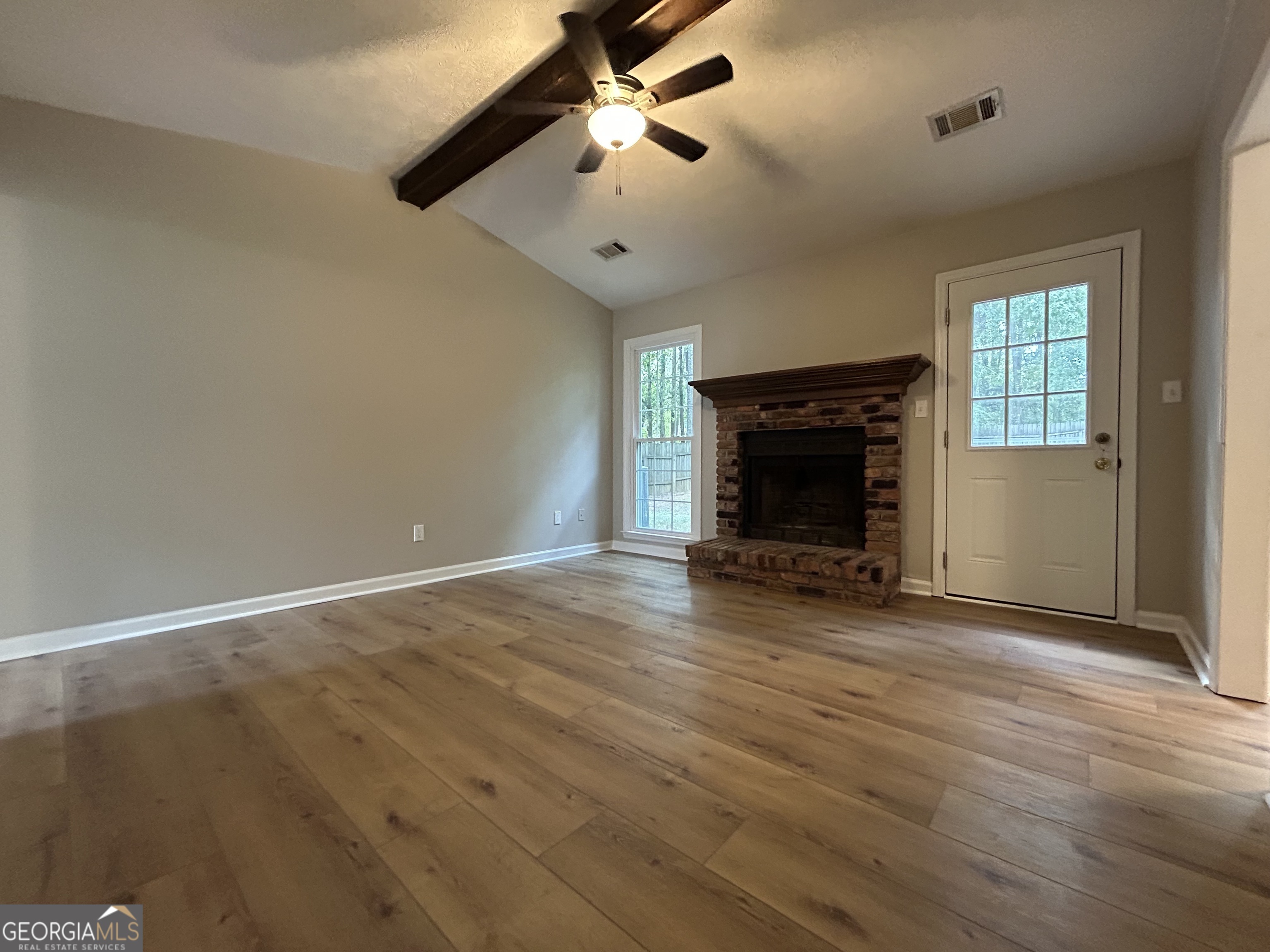 191 Moccasin Trail LaGrange, GA 30241 - Photo 4 of 32 an empty room with windows fireplace and a sink