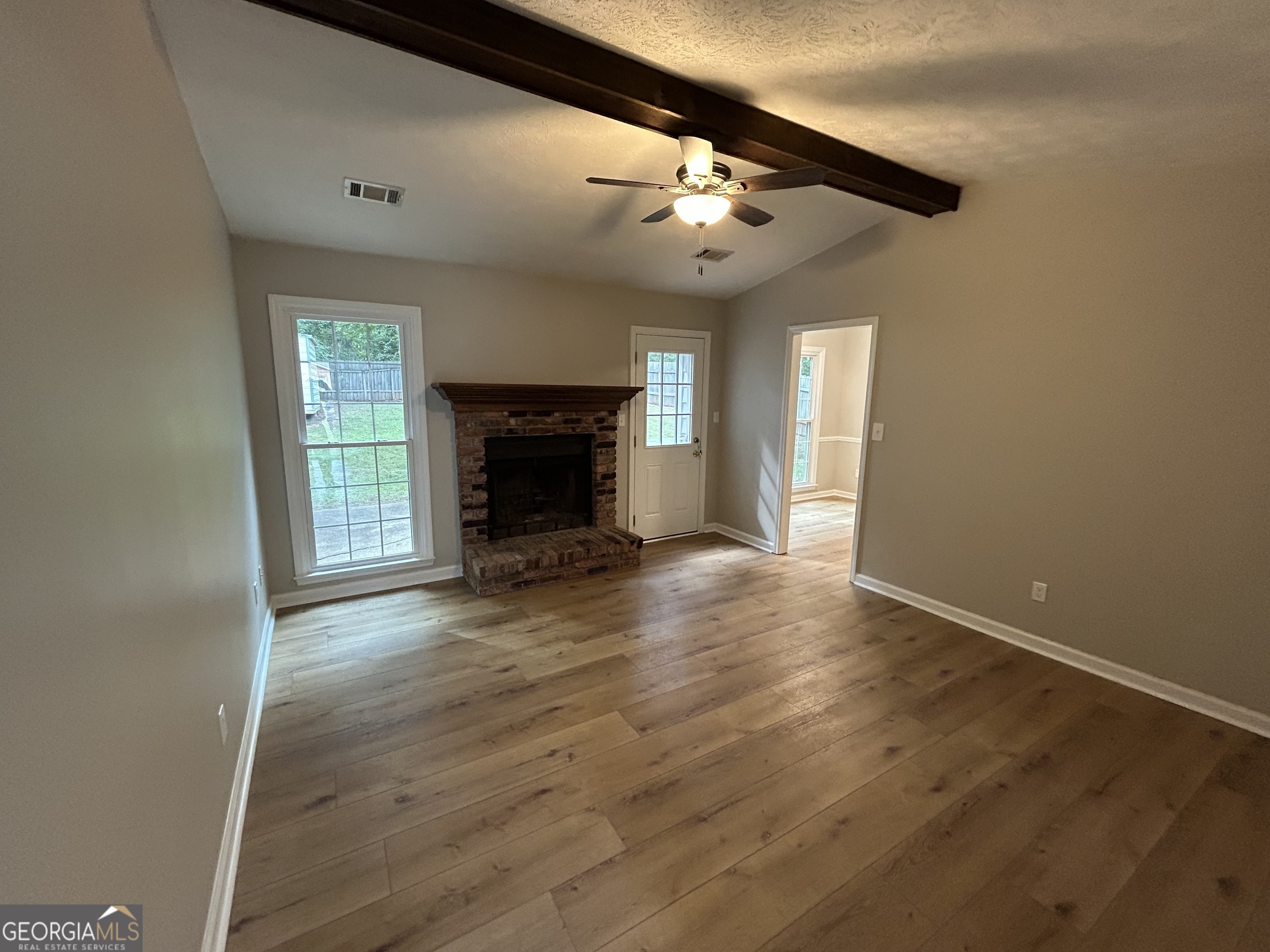191 Moccasin Trail LaGrange, GA 30241 - Photo 5 of 32 wooden floor in an empty room with a fireplace