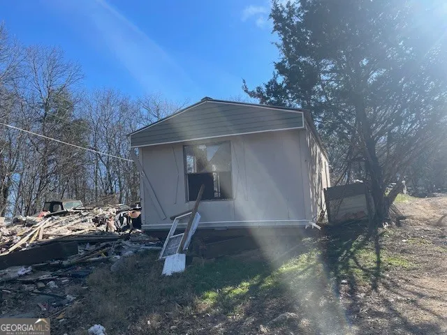 a view of a wooden house with a yard