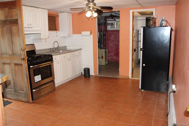 a kitchen with stainless steel appliances a stove a refrigerator and a sink