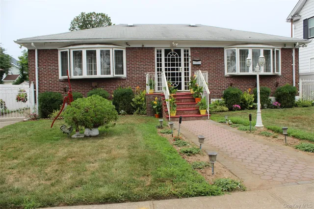 a front view of a house with garden
