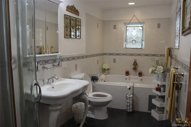 a bathroom with a sink toilet and a mirror