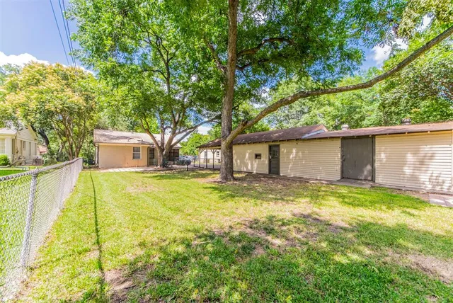 a view of a house with pool and a yard