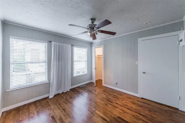 a view of a livingroom with a ceiling fan and window