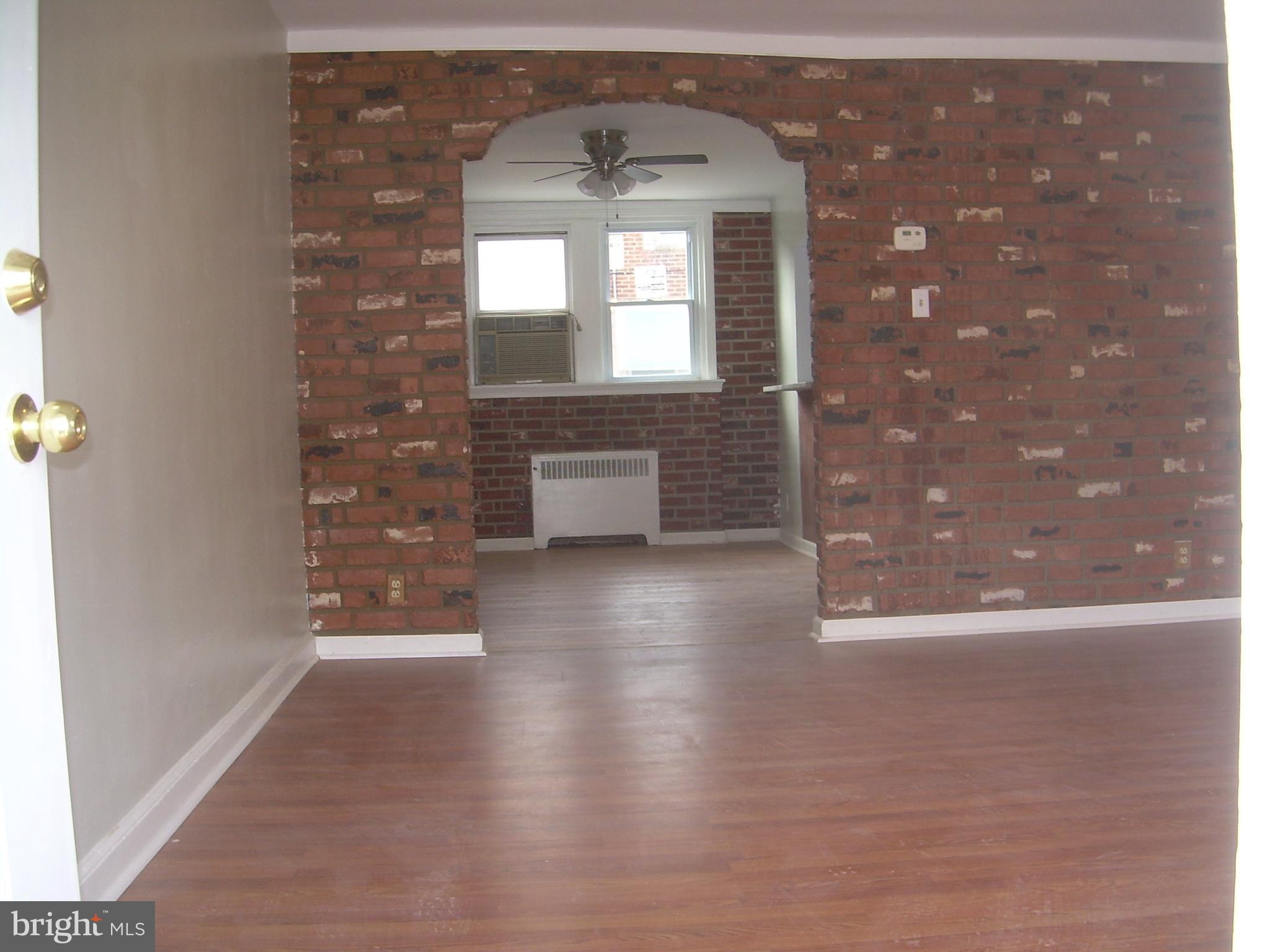 4214 Marple Street Philadelphia, PA 19136 - Photo 4 of 39 wooden floor in an empty room with a window