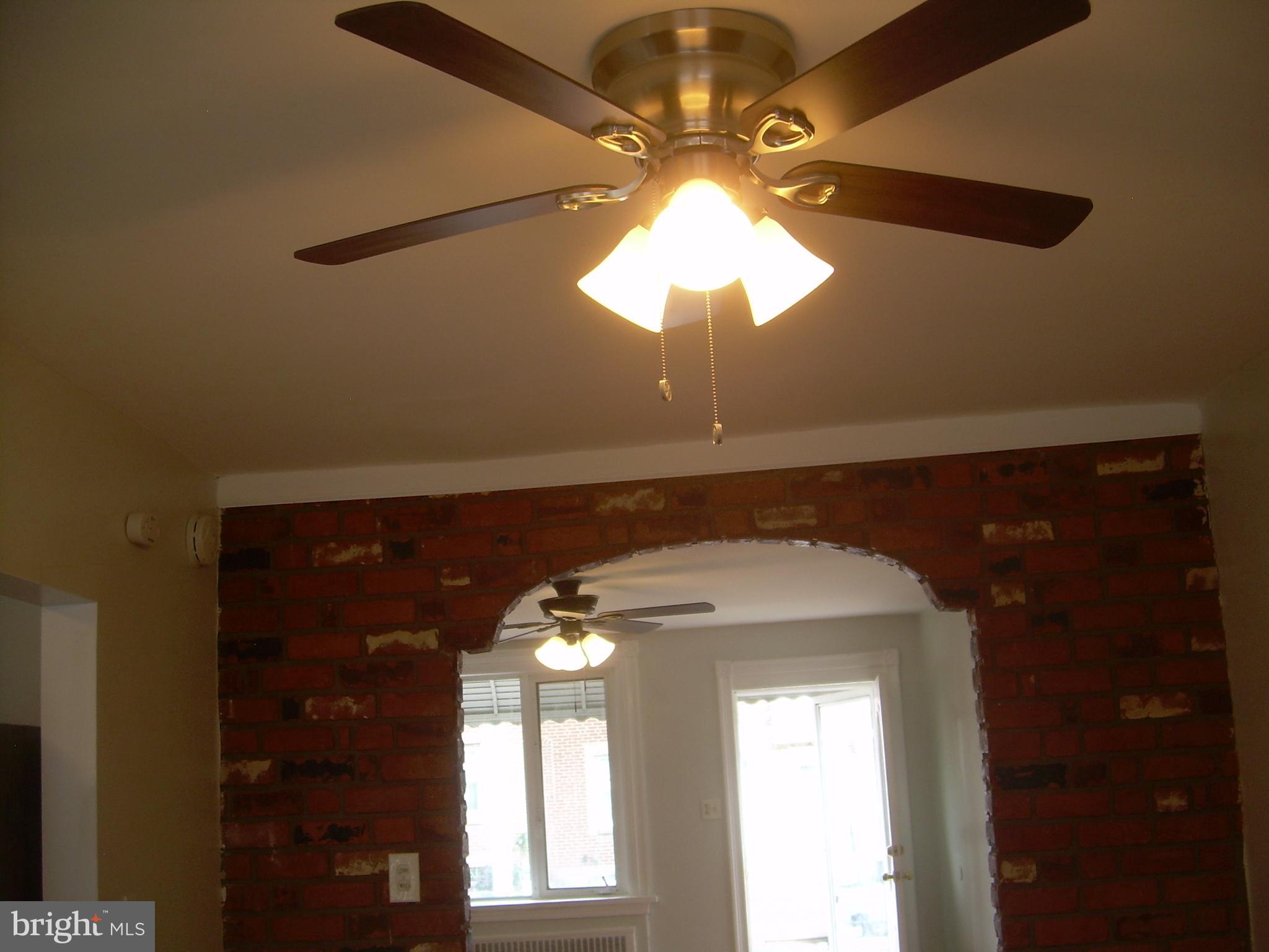 4214 Marple Street Philadelphia, PA 19136 - Photo 7 of 39 a view of a chandelier fan and a fireplace in a room
