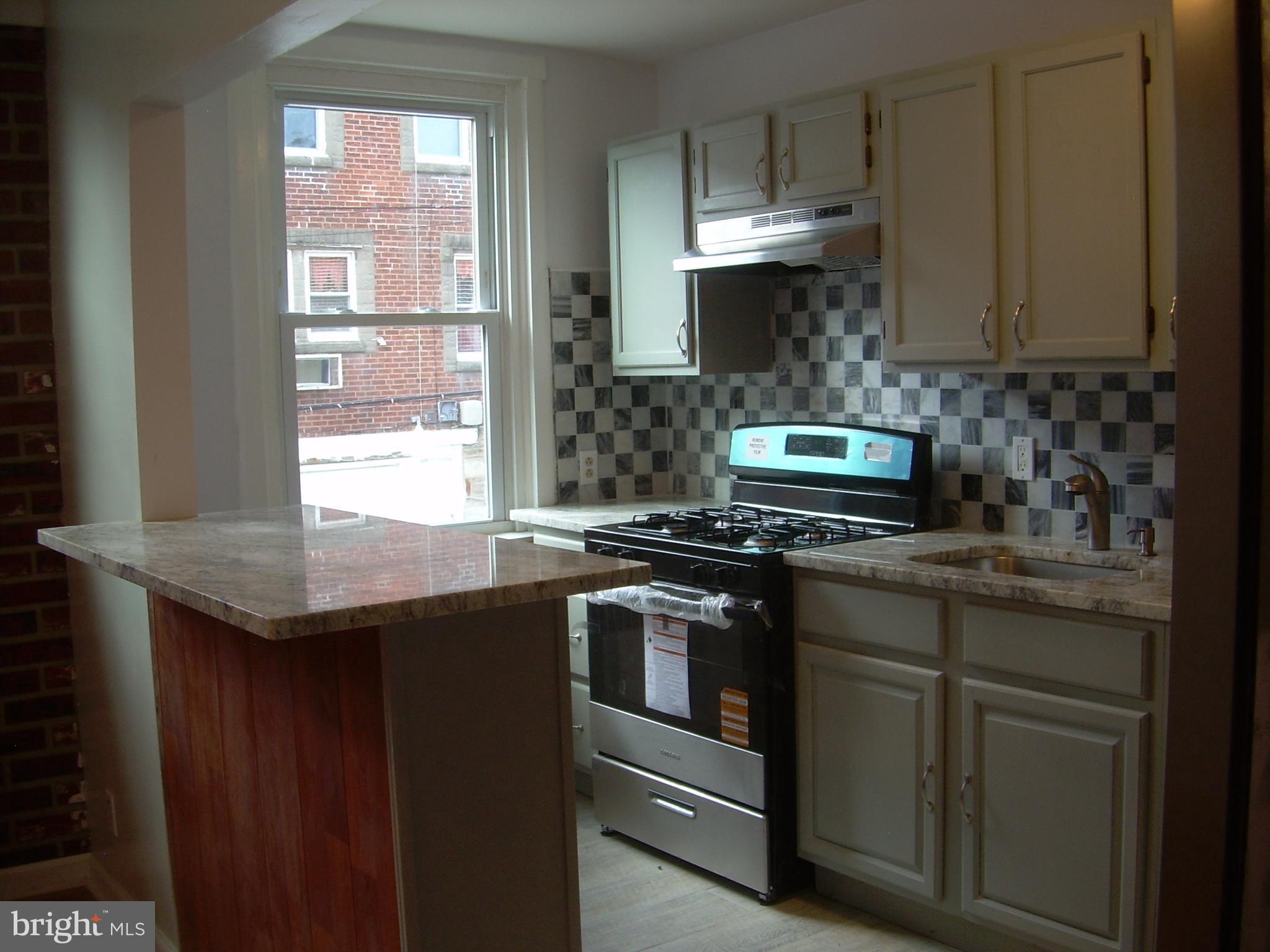 4214 Marple Street Philadelphia, PA 19136 - Photo 10 of 39 a kitchen with stainless steel appliances granite countertop a stove a sink and a refrigerator