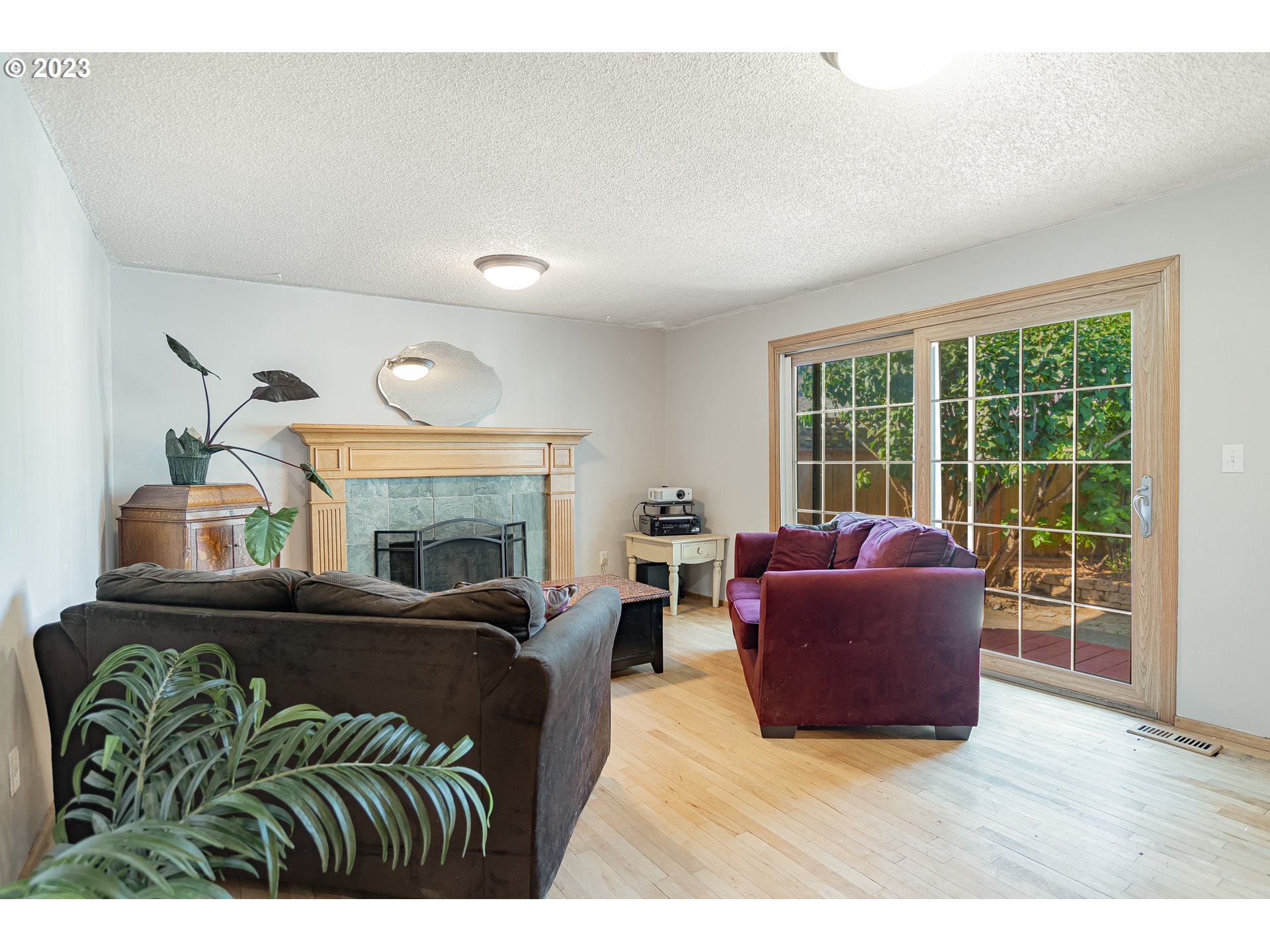 9709 Northwest 19th Avenue Vancouver, WA 98665 - Photo 8 of 27 a living room with furniture a fireplace and a floor to ceiling window