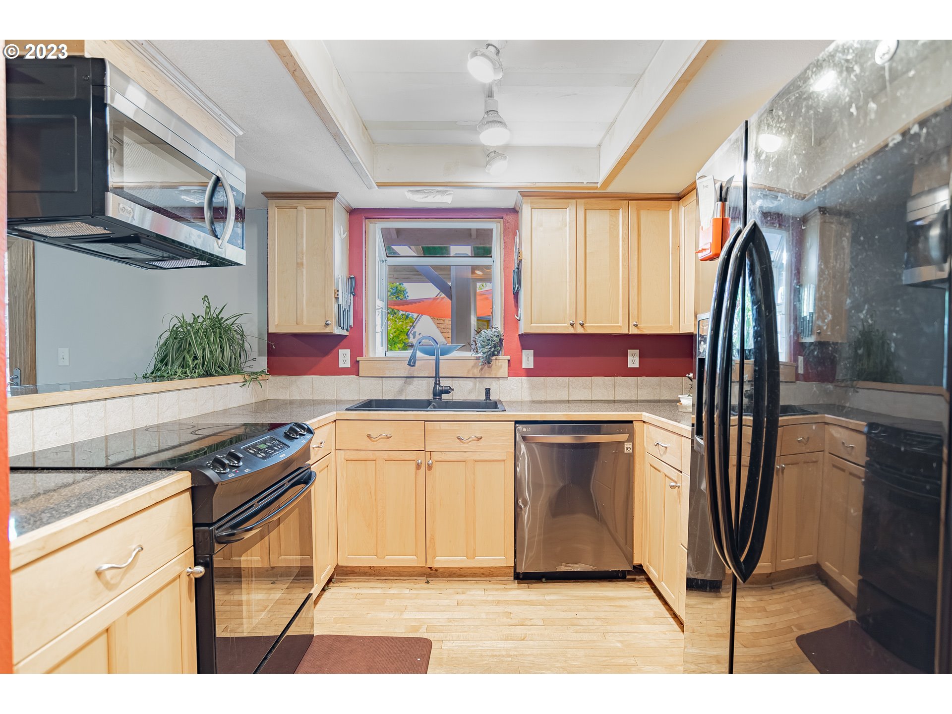 9709 Northwest 19th Avenue Vancouver, WA 98665 - Photo 9 of 27 a kitchen with stainless steel appliances granite countertop a stove a sink and a refrigerator