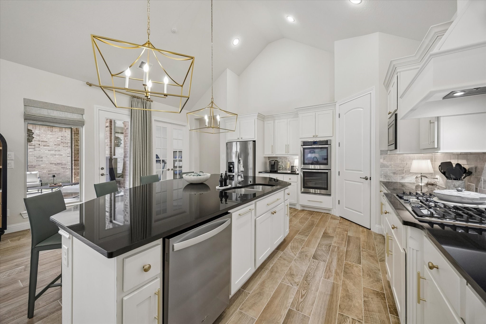 7418 Kearney Hill Lane Spring, TX 77389 - Photo 8 of 35 The kitchen boasts classic granite countertops, a gas cooktop, Whirlpool stainless steel appliances, and double ovens. The chef may also enjoy views of the pool during meal preparation!