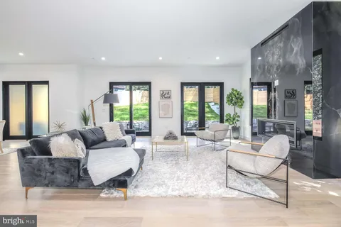 a living room with furniture dining table and a large window