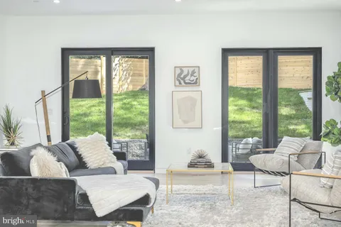 a dining room with furniture a chandelier and wooden floor