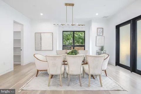 a en suite bathroom with a sink a mirror and a bathtub next to a window