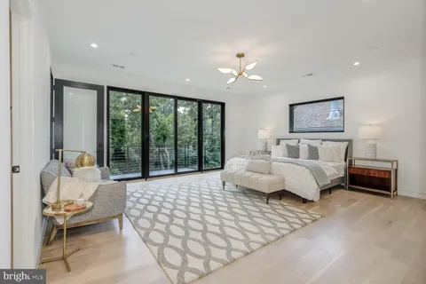 a view of bathroom with a toilet a sink and mirror