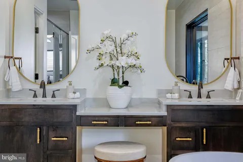 a bathroom with a double vanity sink toilet and bathtub