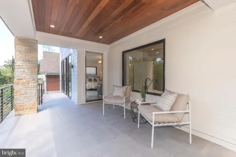 a bedroom with furniture and a large window