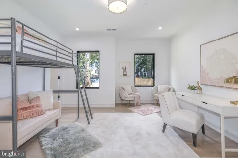 a living room with stainless steel appliances kitchen island granite countertop a sink and cabinets