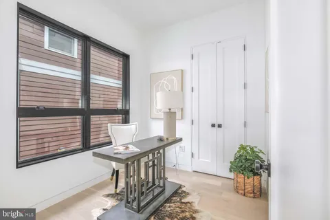 a living room with furniture a rug and white walls