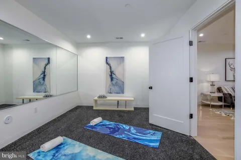 a roof deck with table and chairs couches with wooden floor and fence