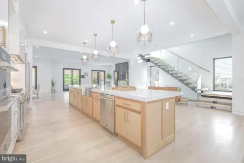 a large white kitchen with a large window