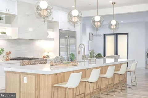 a living room with furniture large windows and wooden floor