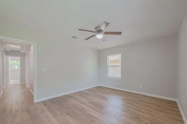 wooden floor in an empty room with a window
