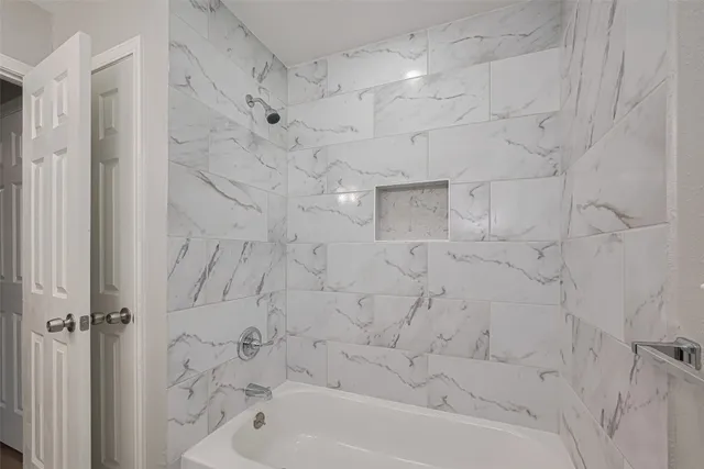 a bathroom with a granite countertop sink a large mirror and a toilet