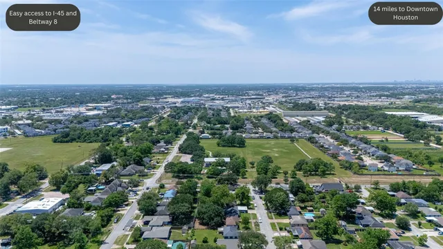 an aerial view of a house with yard