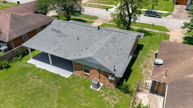 an aerial view of a house with garden space and street view