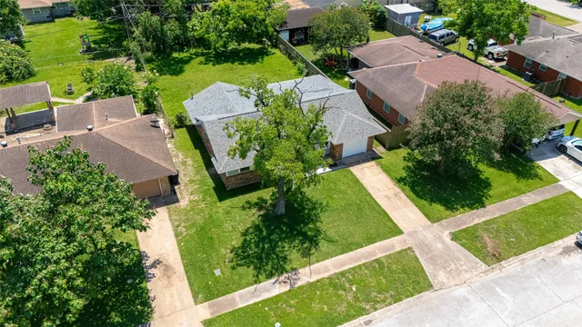 an aerial view of a house with a yard