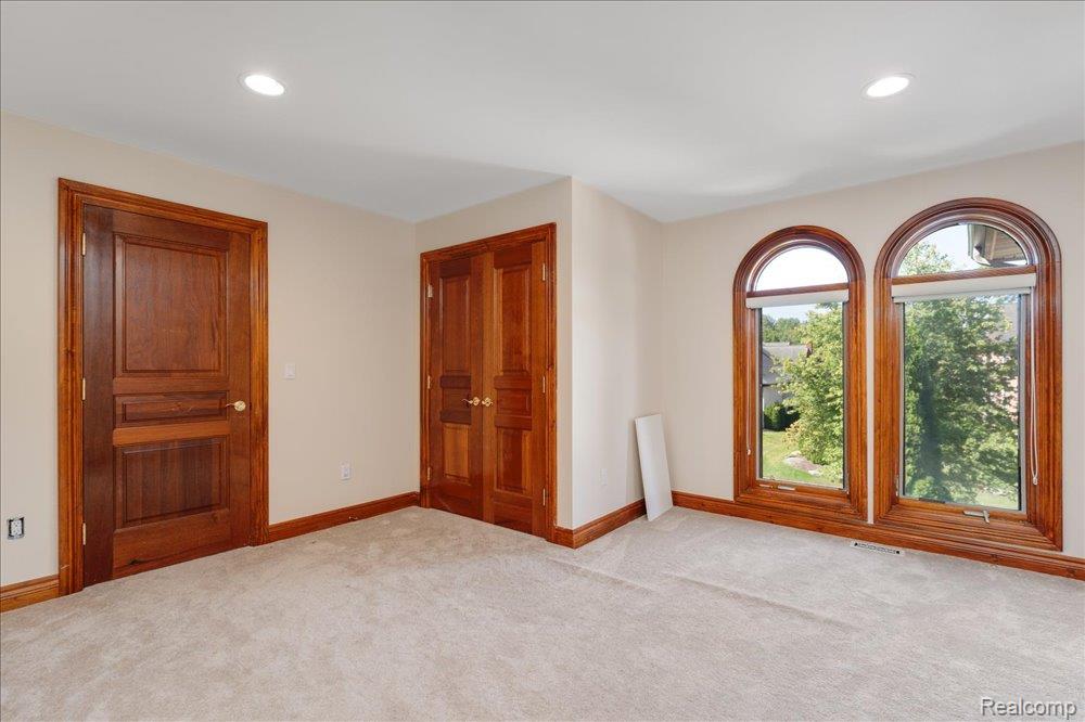 3543 Cedar Brook Drive Rochester, MI 48309 - Photo 67 of 99 Arch-top windows with wood-finish trim, plush carpeting, recessed lighting, and solid wood interior doors
