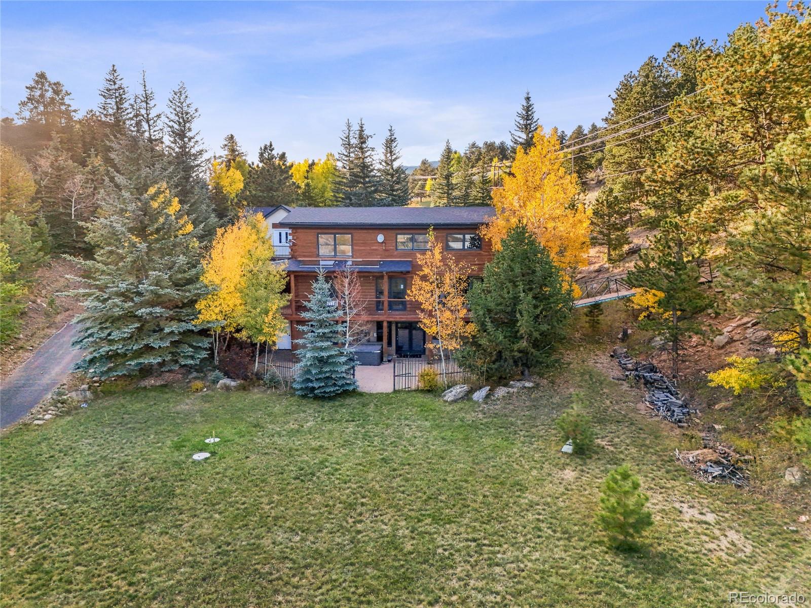 24 Pine Valley Road Evergreen, CO 80439 - Photo 2 of 50 a view of a house with a yard