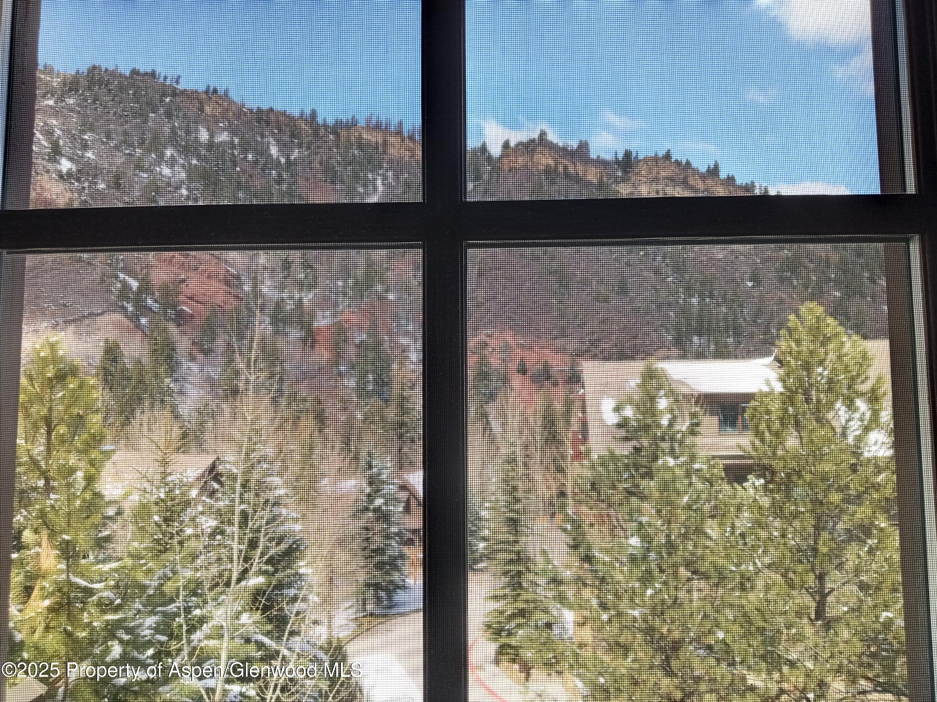 75 Prospector Road, Unit 8204 WINTER INTEREST #5 Aspen, CO 81611 - Photo 38 of 41 a view of a glass door with a view of a lake view