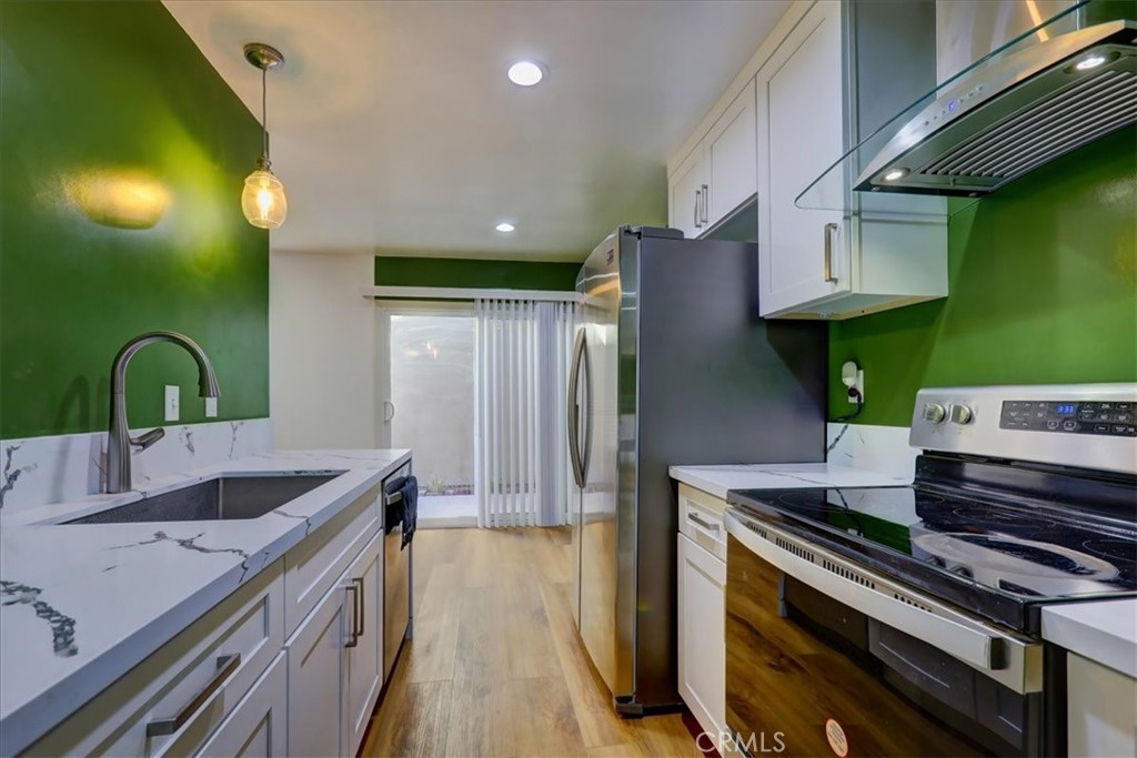 4723 Jackson Street, Unit 25 Riverside, CA 92503 - Photo 13 of 26 a kitchen with stainless steel appliances granite countertop a sink and a stove