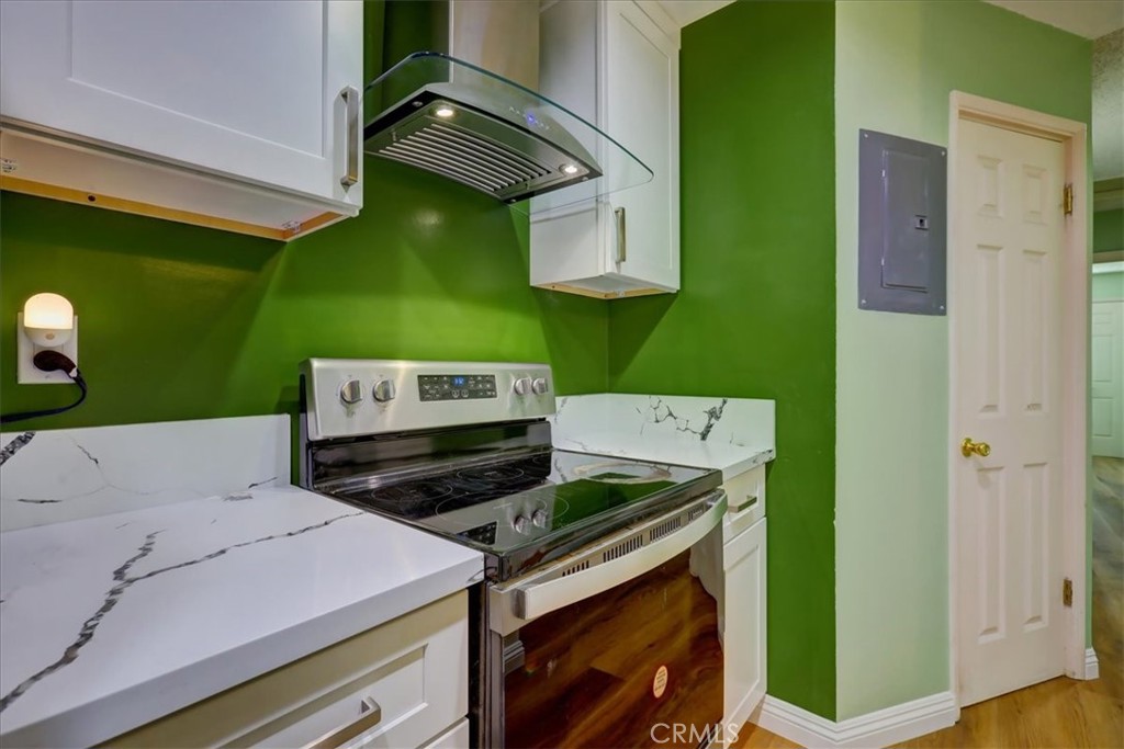4723 Jackson Street, Unit 25 Riverside, CA 92503 - Photo 14 of 26 a kitchen with a stove and a microwave