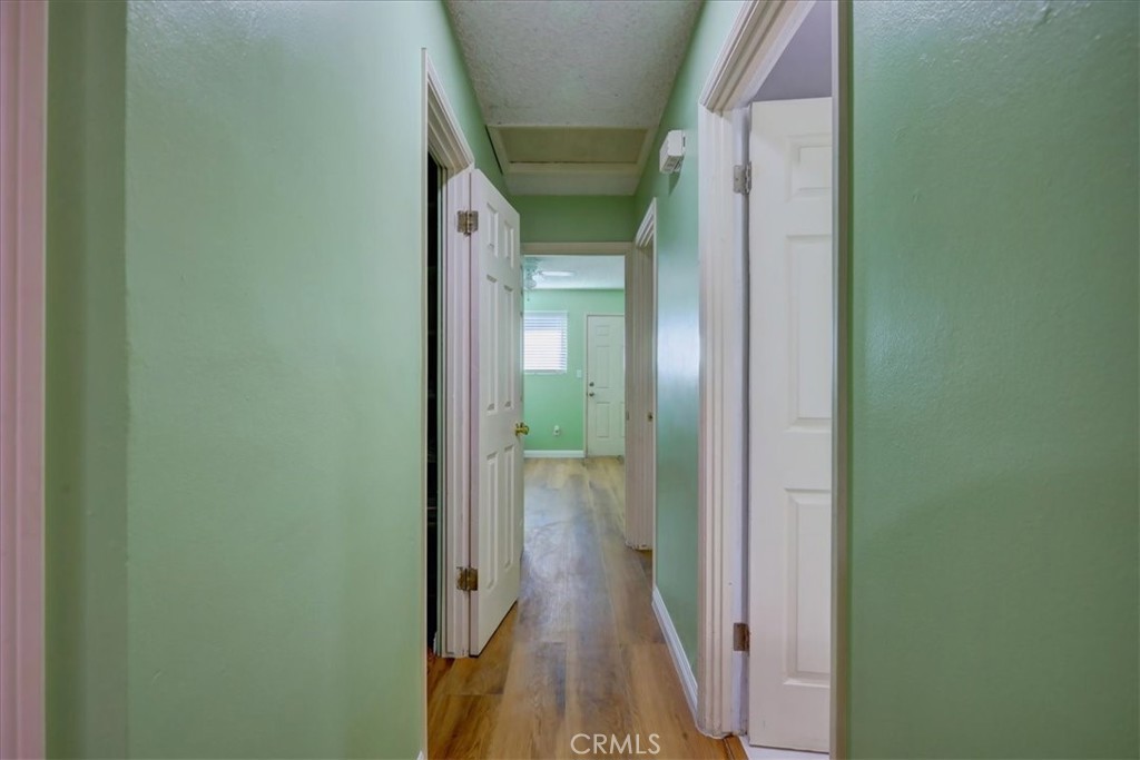 4723 Jackson Street, Unit 25 Riverside, CA 92503 - Photo 16 of 26 a view of a hallway with wooden floor