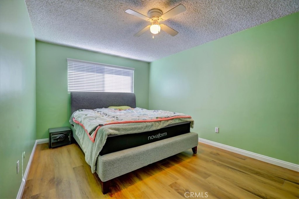 4723 Jackson Street, Unit 25 Riverside, CA 92503 - Photo 17 of 26 a bedroom with a bed and a chandelier