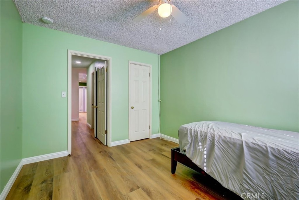 4723 Jackson Street, Unit 25 Riverside, CA 92503 - Photo 21 of 26 a bedroom with a bed and a mirror