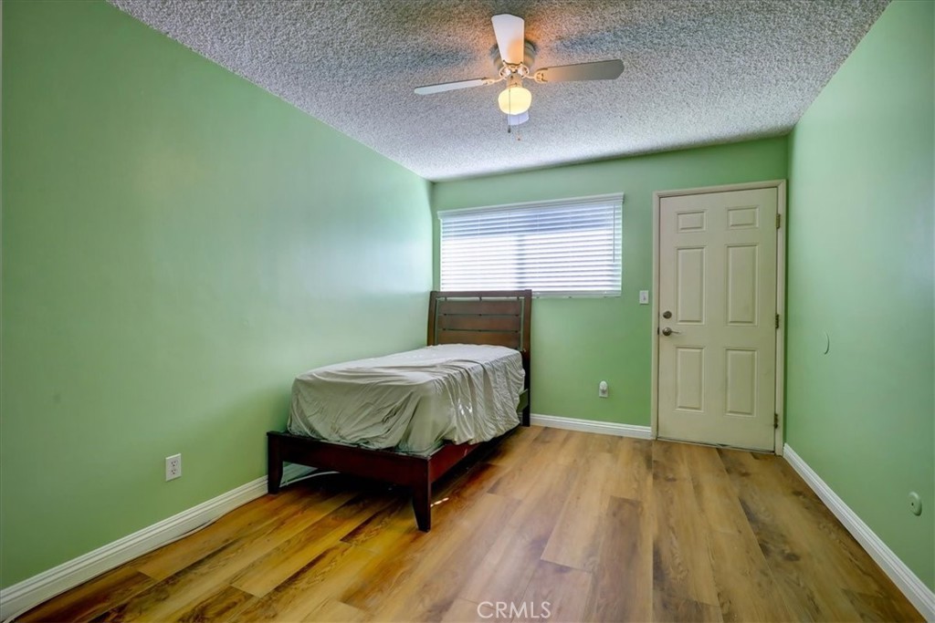 4723 Jackson Street, Unit 25 Riverside, CA 92503 - Photo 22 of 26 a bedroom with a bed and a chandelier