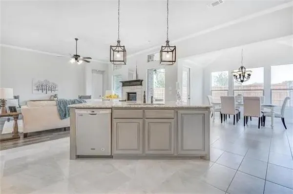 a living room with lots of furniture and kitchen view