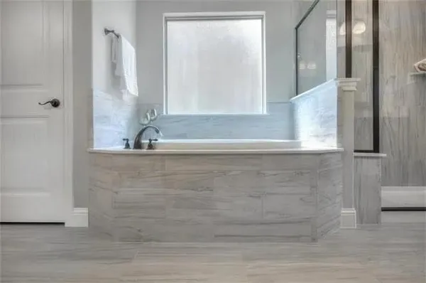 a bathroom with a bathtub and a shower