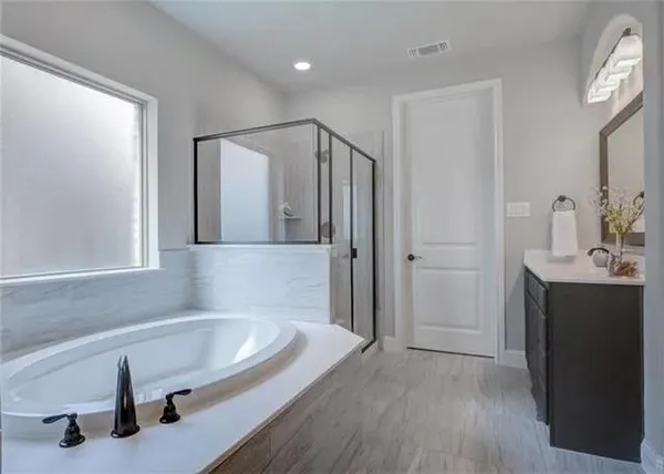 a bathroom with a bathtub and a shower